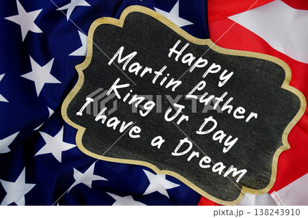 Happy Martin Luther King Jr Day and I have a Dream message written on blackboard with American flag Happy Martin Luther King Jr Day and I have a Dream message written on blackboard with American flag 138243910