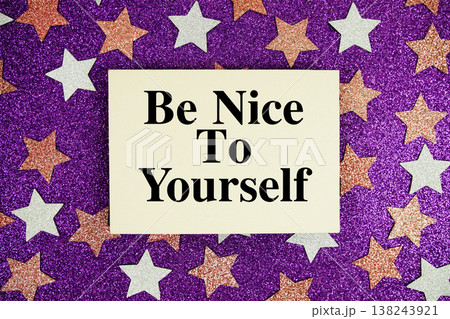 "Be Nice To Yourself" quotes on paper card with purple glitter background with pink and white stars "Be Nice To Yourself" quotes on paper card with purple glitter background with pink and white stars 138243921