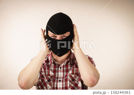 Man wearing black balaclava Man wearing black balaclava 138244361