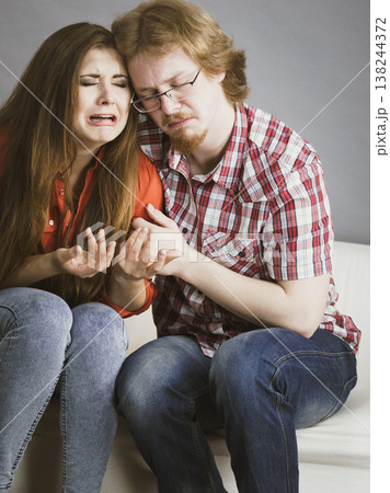 Woman confiding to man on sofa Woman confiding to man on sofa 138244372