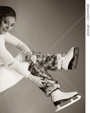 Woman wearing ice skates fur socks, skating 138244480
