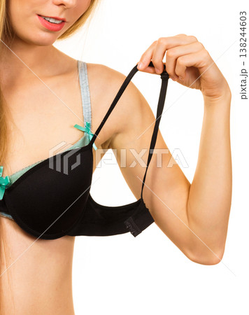 Woman trying on black pushup bra 138244603