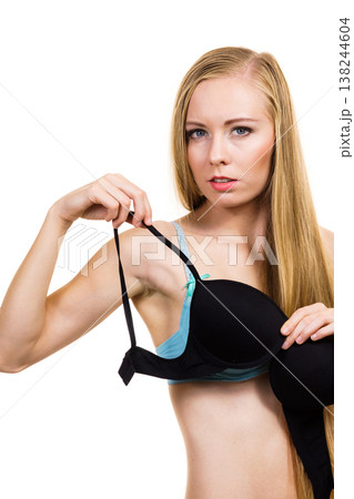 Woman trying on black bra 138244604