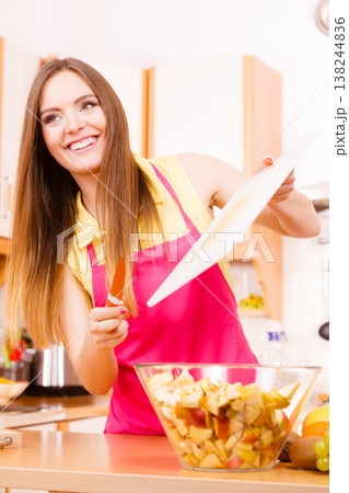 Woman housewife in kitchen cutting apple fruits Woman housewife in kitchen cutting apple fruits 138244836