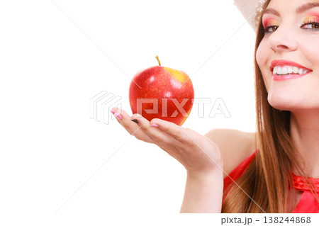 Woman summer hat colorful makeup holds apple fruit Woman summer hat colorful makeup holds apple fruit 138244868
