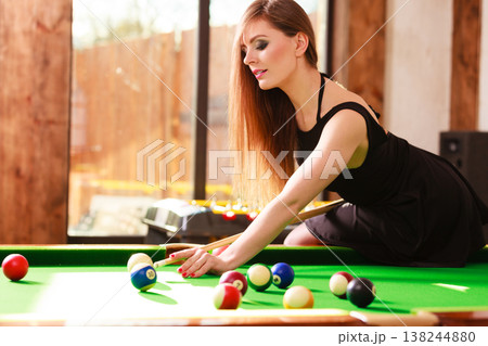 Young woman playing billiard. Young woman playing billiard. 138244880