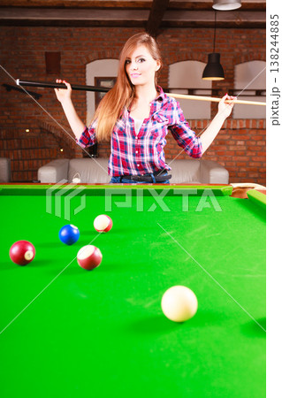 Young woman having fun with billiard. 138244885
