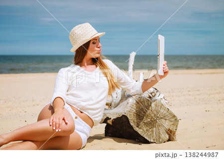 Woman with tablet on beach taking selfie Woman with tablet on beach taking selfie 138244987