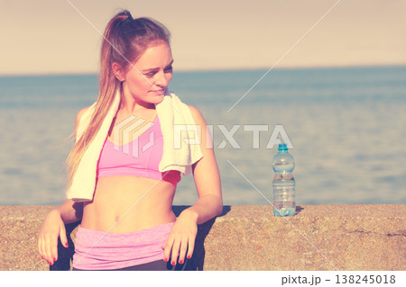 Woman drinking water after sport gym outdoor 138245018