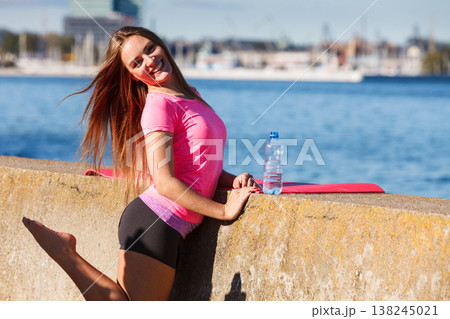 Woman drinking water after sport gym outdoor 138245021