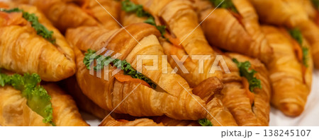 Fresh Baked Croissants . A pile of tasty crispy croissant on restaurant buffet 138245107