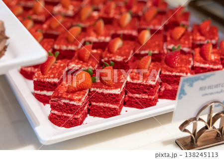 Many pieces of white cake and decorate by pink chocolate heart shape in buffet line. 138245113