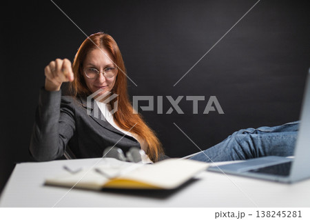 Confident boss woman gesturing with hand at desk Confident boss woman gesturing with hand at desk 138245281