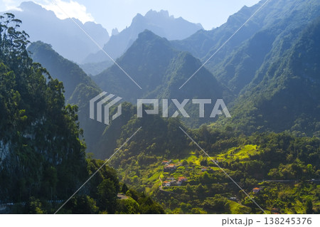 Funchal, Madeira lush mountains, showcasing terraced hills and vibrant greenery. Villages nestled in the valley create a peaceful, harmonious scene 138245376