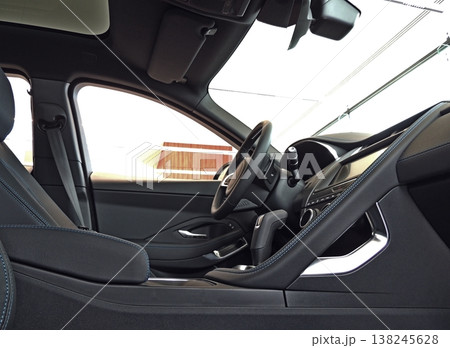 Side view of blue thread stitched front seats with dark leather trim inside a car Side view of blue thread stitched front seats with dark leather trim inside a car 138245628