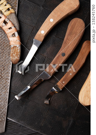 new professional hoof  knives with  rasp for trimming horsy foot at black background. horse hoof care concept 138245760