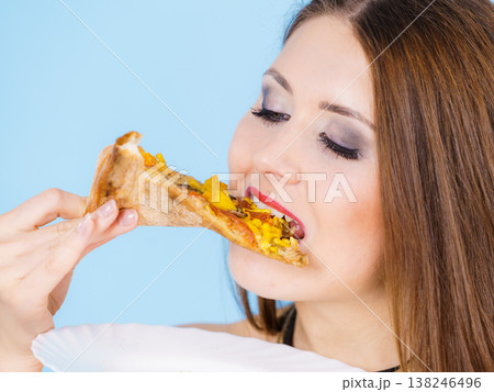 Woman eating hot pizza slice Woman eating hot pizza slice 138246496