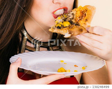 Woman eating hot pizza slice Woman eating hot pizza slice 138246499