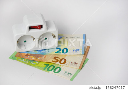 Power strip on euro banknotes showing increasing energy costs 138247017