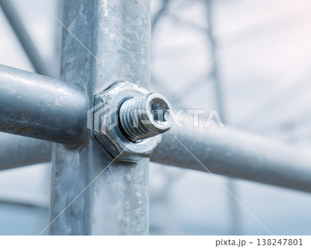Close-up of metallic bolt and nut on power tower structure for energy infrastructure 138247801