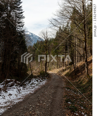 Gravel forest road in late winter with mountain view in Bavaria Gravel forest road in late winter with mountain view in Bavaria 138249927