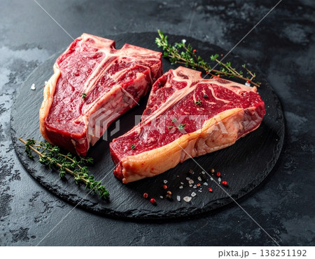 T-bone steaks against a dark backdrop 138251192