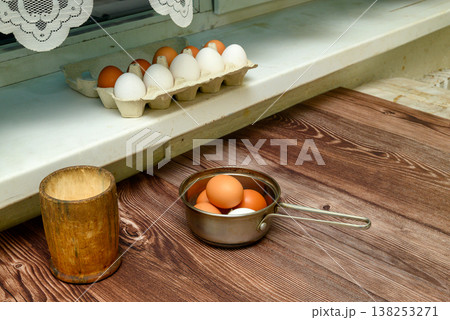 chicken eggs on a wooden table in a kitchen interior chicken eggs on a wooden table in a kitchen interior 138253271