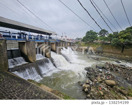 An aerial drone perspective reveals the historic Katulampa Dam spanning the Ciliwung River in Bogor 138254199