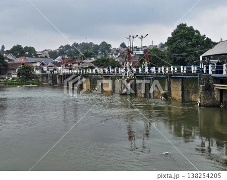 An aerial drone perspective reveals the historic Katulampa Dam spanning the Ciliwung River in Bogor An aerial drone perspective reveals the historic Katulampa Dam spanning the Ciliwung River in Bogor 138254205