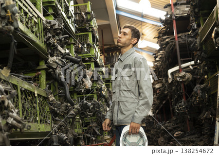 Technician worker feeling tired and frustration from working in garage scrap yard car workshop warehouse. Technician worker feeling tired and frustration from working in garage scrap yard car workshop warehouse. 138254672