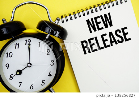 New Release text with alarm clock flat lay on yellow background New Release text with alarm clock flat lay on yellow background 138256827