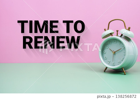 Black alarm clock on a pastel green and pink background with the text "Time To Renew" Black alarm clock on a pastel green and pink background with the text "Time To Renew" 138256872