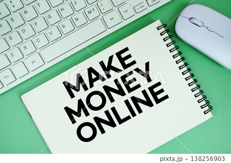 Notepad with the text "Make Money Online" with white keyboard and wireless mouse on green background Notepad with the text "Make Money Online" with white keyboard and wireless mouse on green background 138256903
