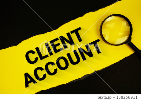 Client Account text on yellow with black paper torn ripped and magnifying glass Client Account text on yellow with black paper torn ripped and magnifying glass 138256911