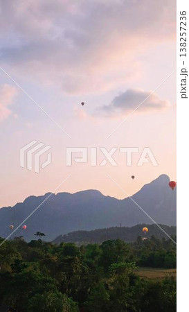 Looking at the rising hot air balloon Looking at the rising hot air balloon 138257236