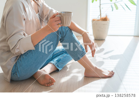 リビングでホットドリンクを飲むおしゃれな女性 リビングでホットドリンクを飲むおしゃれな女性 138258578