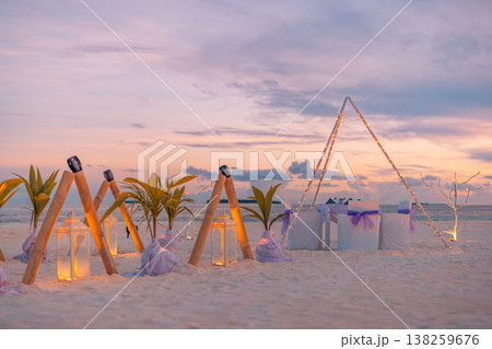 Tropical beach destination wedding setup with candles, flowers, and table chairs, radiant romantic honeymoon background Tropical beach destination wedding setup with candles, flowers, and table chairs, radiant romantic honeymoon background 138259676