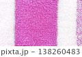 Close-up view of a soft, absorbent terry cloth towel featuring vibrant pink and white stripes. Ideal for backgrounds, textiles, and design projects. 138260483