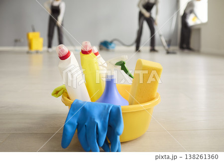 Janitorial cleaning crew and bucket of supplies on polished floor indoors 138261360