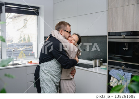 Woman embraces man in apron before cooking 138261688