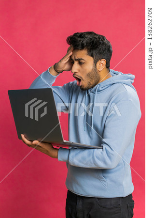 Displeased Indian man use laptop surprised by bad news, fortune loss, game fail, lottery results 138262709