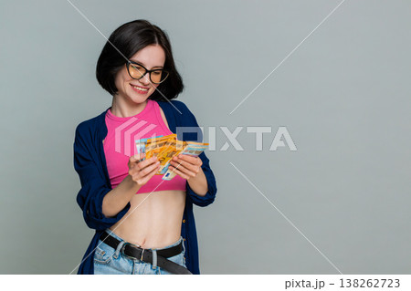 Young woman smiling counting cash euro money expressing financial success profit earnings wealth Young woman smiling counting cash euro money expressing financial success profit earnings wealth 138262723
