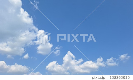 Clear vibrant blue sky with beautiful white fluffy clouds on sunny day Clear vibrant blue sky with beautiful white fluffy clouds on sunny day 138263030