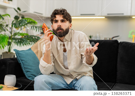 Indian man smartphone night spam call angry tired user ending conversation hangs up frustrated quick Indian man smartphone night spam call angry tired user ending conversation hangs up frustrated quick 138263371