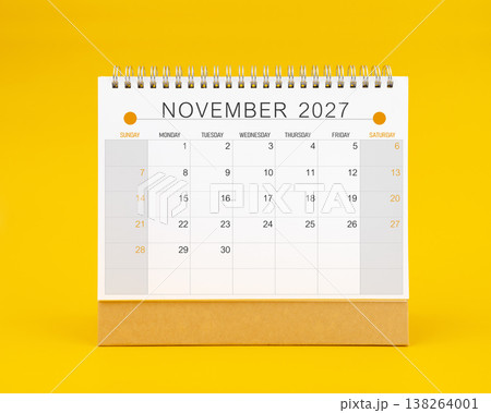November 2027 desk calendar on yellow color background, Front view. 138264001