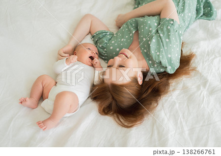 Happy family at home. Mother holding little baby toddler child feeding milk from bottle. Newborn Infant baby girl sucking eating drinking milk. Mom of breast feeding baby. Motherhood happy child Happy family at home. Mother holding little baby toddler child feeding milk from bottle. Newborn Infant baby girl sucking eating drinking milk. Mom of breast feeding baby. Motherhood happy child 138266761