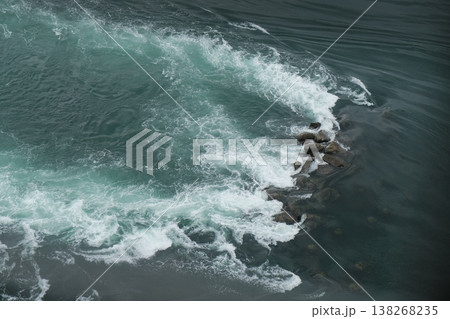 Turbulent Ocean Waves Crashing Against Rocks Turbulent Ocean Waves Crashing Against Rocks 138268235