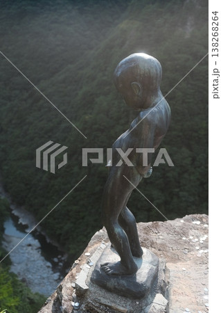 Bronze Statue Reaching Towards Tranquil Garden Bronze Statue Reaching Towards Tranquil Garden 138268264