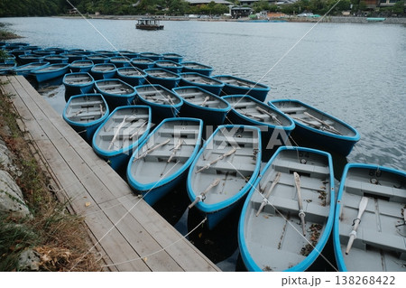 Rows of Blue Boats on Calm Water Rows of Blue Boats on Calm Water 138268422