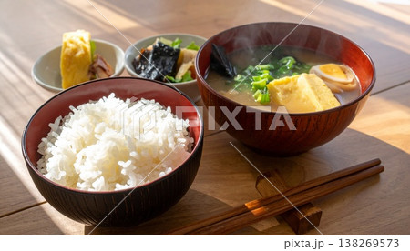 朝の光が差し込む木製テーブルの上の美味しそうなおかずと味噌汁とご飯 朝の光が差し込む木製テーブルの上の美味しそうなおかずと味噌汁とご飯 138269573